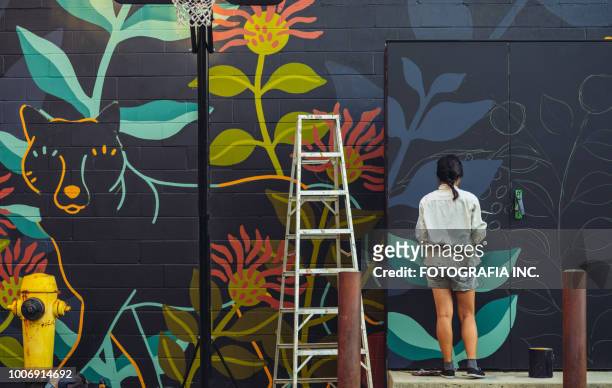 mural artist at work - city life stock pictures, royalty-free photos & images