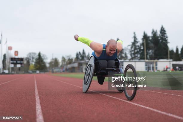 adaptive athlete training on his racing wheelchair - paraplegic race stock pictures, royalty-free photos & images