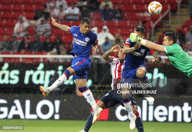 Guadalajara's Mexican goalkeeper Raul Gudino vies for the ball with Cruz Azul's Mexican midfielder Julio Dominguez and Mexican midfielder Edgar...