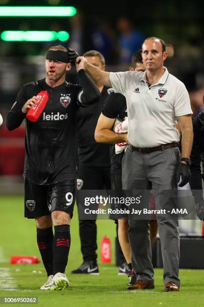 Wayne Rooney of DC United receives treatment for a bloody nose after a challenge with Axel Sjoberg of Colorado Rapids during the MLS match between DC...