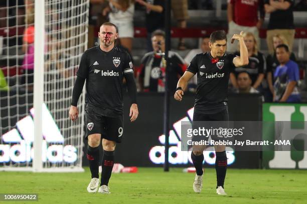 Wayne Rooney of DC United receives a bloody nose after a challenge with Axel Sjoberg of Colorado Rapids during the MLS match between DC United and...