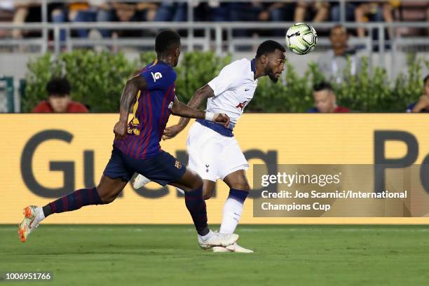 Georges-Kévin N'Koudou of Tottenham Hotspur heads the ball in front of Nelson Semedo of FC Barcelona during an International Champions Cup match at...
