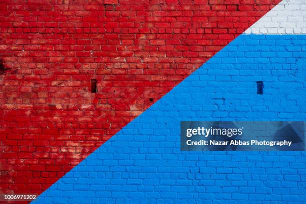 red and blue brick wall background. - red wall stock pictures, royalty-free photos & images