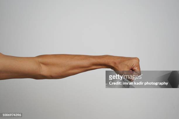 body part cropped hand in grey background - menschlicher arm stock-fotos und bilder