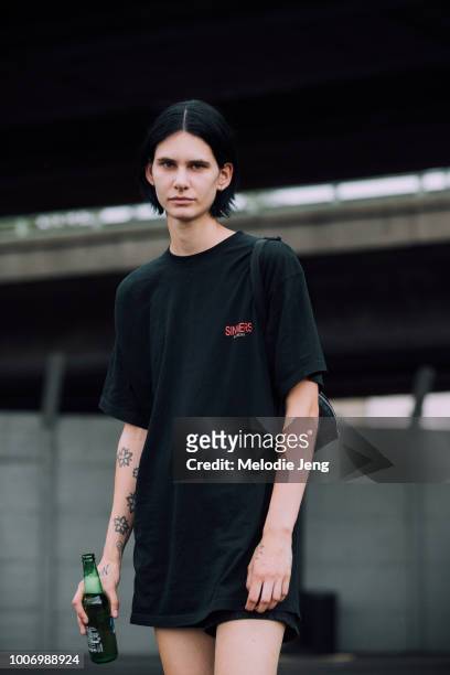 Model Niki Geux wears a black Balenciaga "Sinners" t-shirt after the Vetements show during Couture Fall/Winter 2018 Fashion Week on July 1, 2018 in...