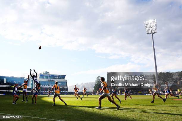Majak Daw of the Kangaroos leaps for a high mark attempt during the round 19 AFL match between the North Melbourne Kangaroos and the West Coast...