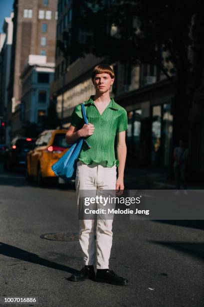 Model Filip Schamis wears a green pleated blouse, tan corduroy pants, a blue totebag, and black shoes after the N Hoolywood show during New York...