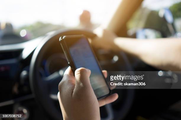 traveller use smartphone and nevigate route for start journey - steering wheel stock-fotos und bilder