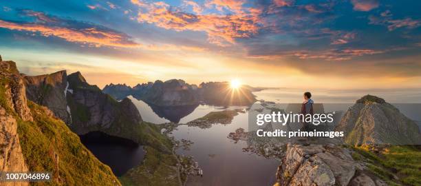 traveller enjoy summer view of lofoten islands in norway with sunset scenic - sunset mountains stock pictures, royalty-free photos & images