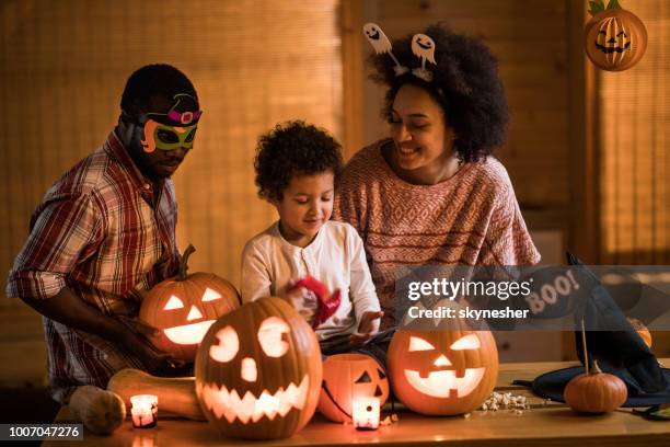 happy african american family enjoying in halloween at home. - inside of pumpkin stock pictures, royalty-free photos & images