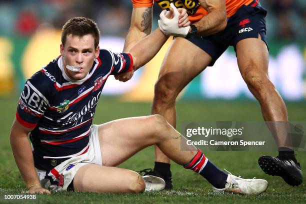 Luke Keary of the Roosters is assisted from the field after injuring himself during the round 20 NRL match between the Sydney Roosters and the St...