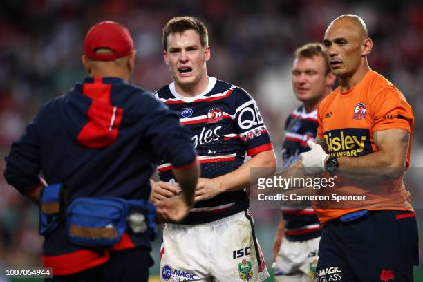 Luke Keary of the Roosters is assisted from the field after injuring himself during the round 20 NRL match between the Sydney Roosters and the St...