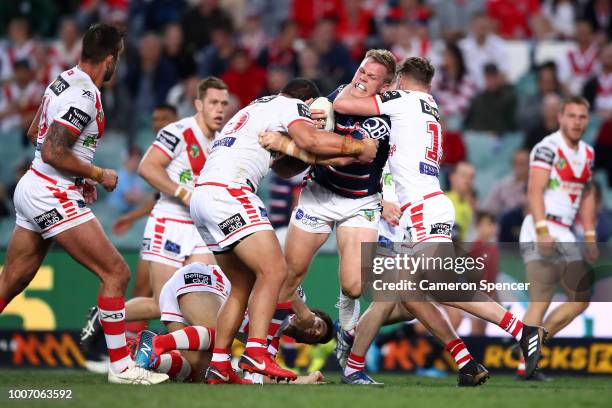 Lindsay Collins of the Roosters is tackled during the round 20 NRL match between the Sydney Roosters and the St George Illawarra Dragons at Allianz...