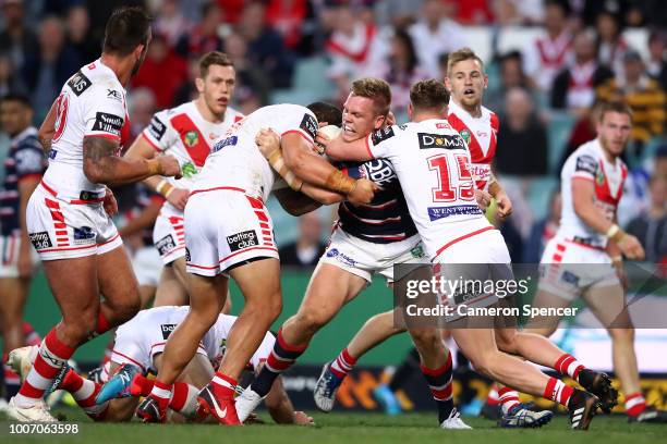 Lindsay Collins of the Roosters is tackled during the round 20 NRL match between the Sydney Roosters and the St George Illawarra Dragons at Allianz...