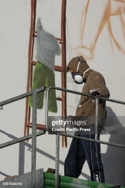 Street artist Jorit Agoch at work on a graffiti mural. The Neapolitan street artist Jorit Agoch was arrested by the Israeli police in Bethlehem....