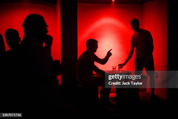 Revellers pause for a drink at the Nest nightclub in Dalston, the weekend before new licensing rules come in to effect across Hackney on July 29,...