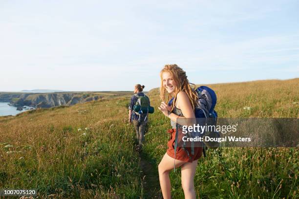 couple hiking along atlantic coastline. - sabbatical stockfoto's en -beelden