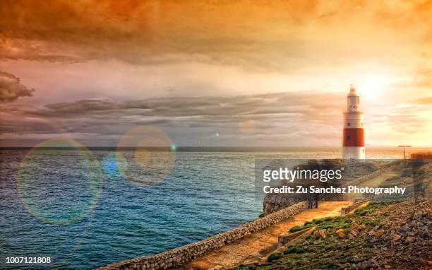 surreal lighthouse - lighthouse sunset stock pictures, royalty-free photos & images
