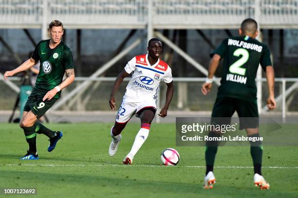 Wout Weghorst of Wolfsburg and Ferland Mendy of Lyon during the friendly match between Olympique Lyonnais and Wolfsburg at Stade Marcel-Verchere on...