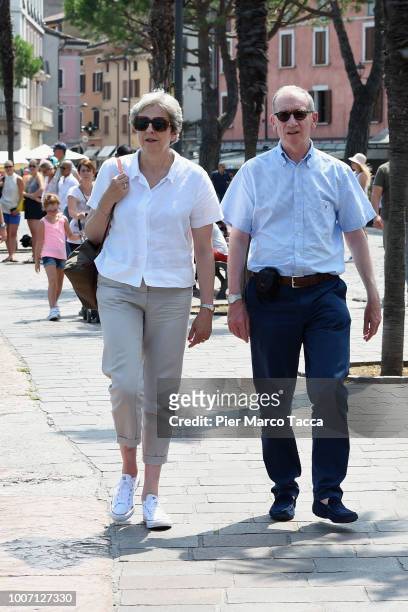 British Prime Minister Theresa May, walks with her husband Philip whilst on vacation in Italy, July 29, 2018 in Desenzano del Garda, Italy.