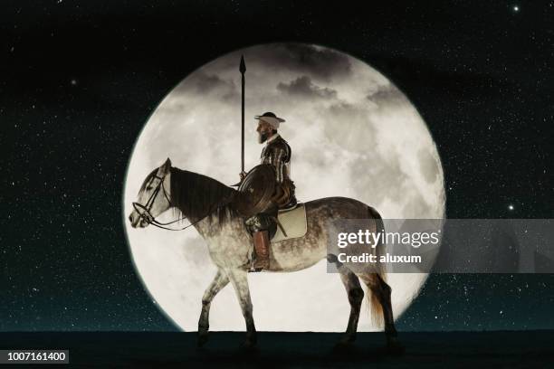 don quijote montado en su caballo contra la luna llena - don quijote de la mancha fotografías e imágenes de stock