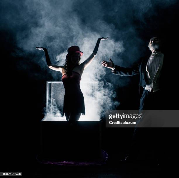 magician performance. disappearance trick - magician stock pictures, royalty-free photos & images