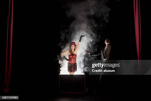 magician performance. disappearance trick - magician stage stock pictures, royalty-free photos & images