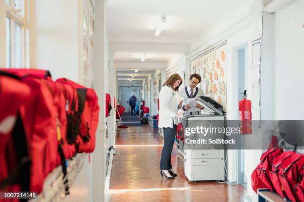 school teachers using the photocopier - photocopier stock pictures, royalty-free photos & images