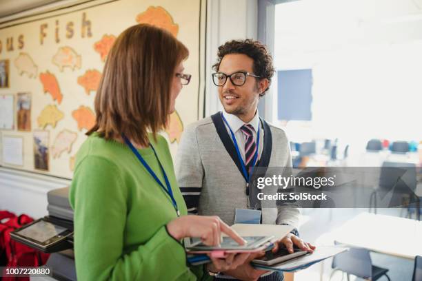 school teachers discussing work - teacher man stock pictures, royalty-free photos & images