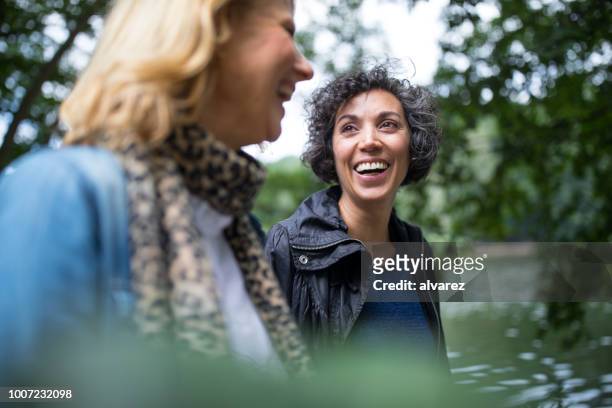 feliz mujer madura busca amigo en bosque - differential focus fotografías e imágenes de stock