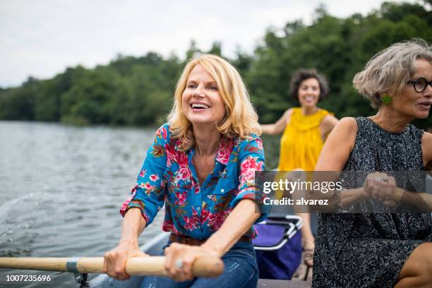 smiling woman with friend rowing boat in lake - 4:3 stock pictures, royalty-free photos & images