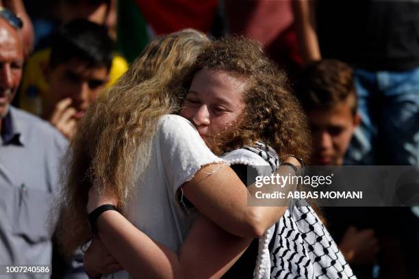 Palestinian activist and campaigner Ahed Tamimi is hugged by her Israeli lawyer Gaby Lasky in the West Bank village of Nabi Saleh on July 29 upon her...