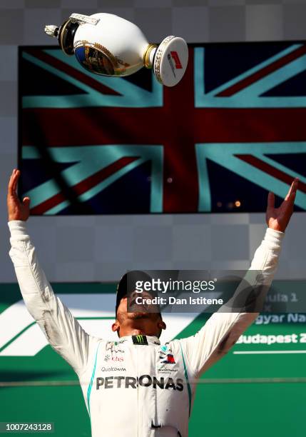 Race winner Lewis Hamilton of Great Britain and Mercedes GP celebrates with his trophy on the podium during the Formula One Grand Prix of Hungary at...