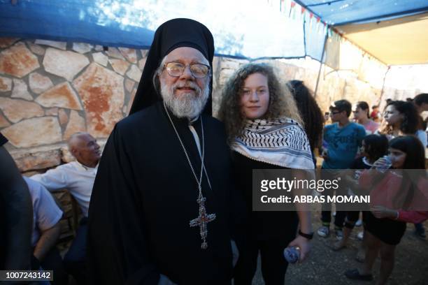 Palestinian activist and campaigner Ahed Tamimi poses for a picture with Archimandrite Abdullah Yulio, parish priest of the Melkite Greek Catholic...