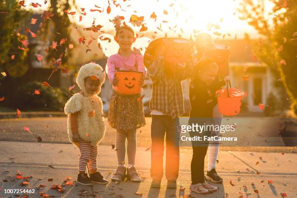 multiethnic group of kids trick or treating - halloween stock pictures, royalty-free photos & images