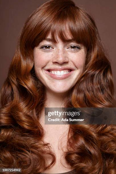 smiling woman with windblown red long hair - gelatinous stock pictures, royalty-free photos & images