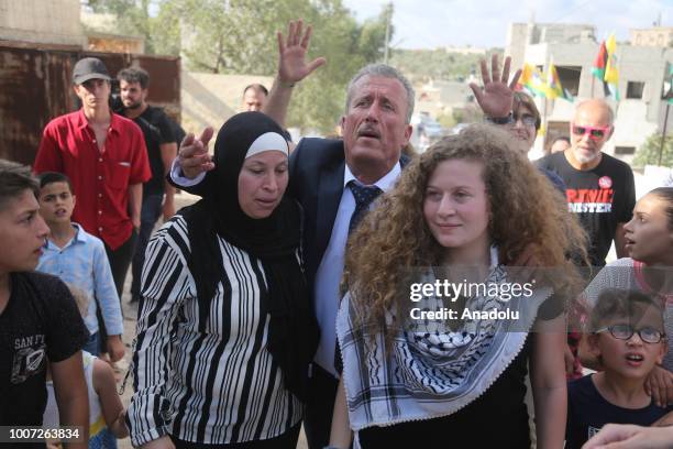 Palestinian teenager Ahed al-Tamimi and her mother Nariman Tamimi and her father Basil Tamimi are welcomed by press members and citizens at the...