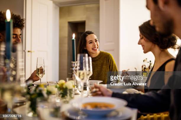 smiling woman talking with friends while having dinner - dinner party stock pictures, royalty-free photos & images