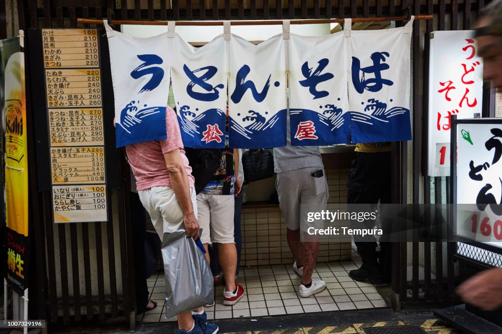 Group of people eating at a small restaurant in Shinseka