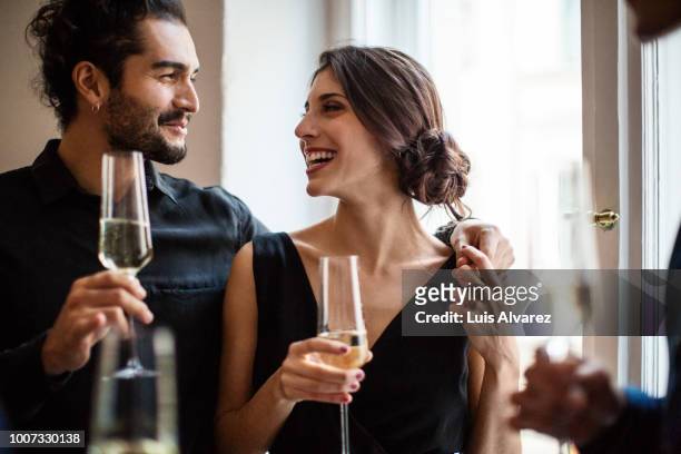 couple holding champagne flutes - elegant couple ストックフォトと画像