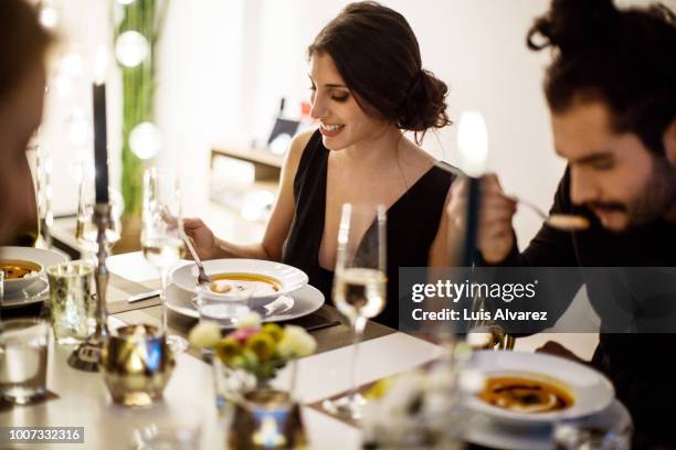 woman having squash soup at dining table - scodella per zuppa foto e immagini stock
