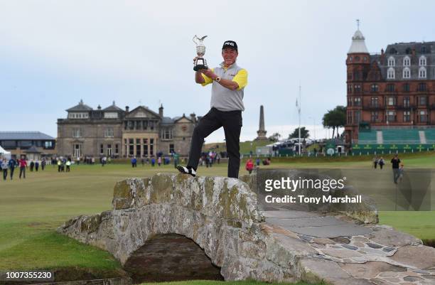 Miguel Angel Jimenez of Spain poses with the Senior Open Trophy on the Swilken Bridge after winning the Senior Open Presented by Rolex during the...