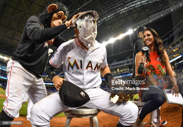 Martin Prado of the Miami Marlins is creamed by The Monkey during an interview after beating the Washington Nationals at Marlins Park on July 29,...