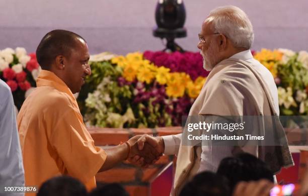 Prime Minister Narendra Modi and Uttar Pradesh Chief Minister Yogi Adityanath greets each other at a mega ground-breaking event at Indira Gandhi...