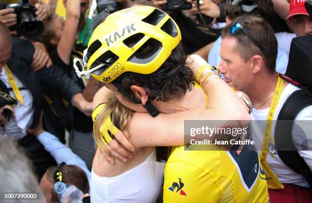 Winner of the Tour yellow jersey Geraint Thomas of Great Britain and Team Sky celebrates with his wife Sara Elen Thomas following stage 21 of Le Tour...