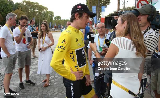 Winner of the Tour yellow jersey Geraint Thomas of Great Britain and Team Sky answers to an interview while his wife Sara Elen Thomas looks on...