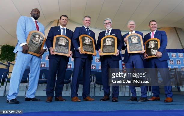 Inductees Vladimir Guerrero, Trevor Hoffman, Chipper Jones, Jack Morris, Alan Trammell and Jim Thome pose for a photograph with the plaques at Clark...