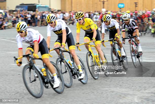 Yellow jersey Geraint Thomas of Great Britain and Team Sky surrounded by Michal Kwiatkowski of Poland and Team Sky, Chris Froome of Great Britain and...