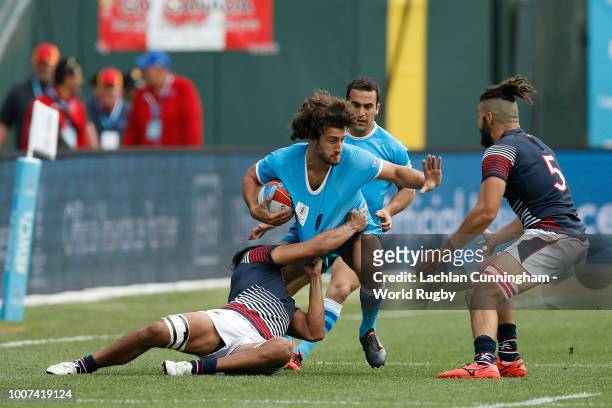 Diego Ardao of Uruguay is tackled by Michael Coverdale of Hong Kong during day three of the Rugby World Cup Sevens at AT&T Park on July 22, 2018 in...
