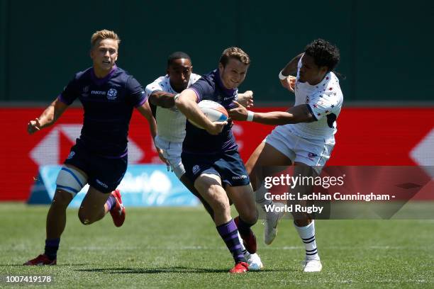 Max McFarland of Scotland is pursued by Perry Baker and Maka Unufe of the United States during day three of the Rugby World Cup Sevens at AT&T Park...